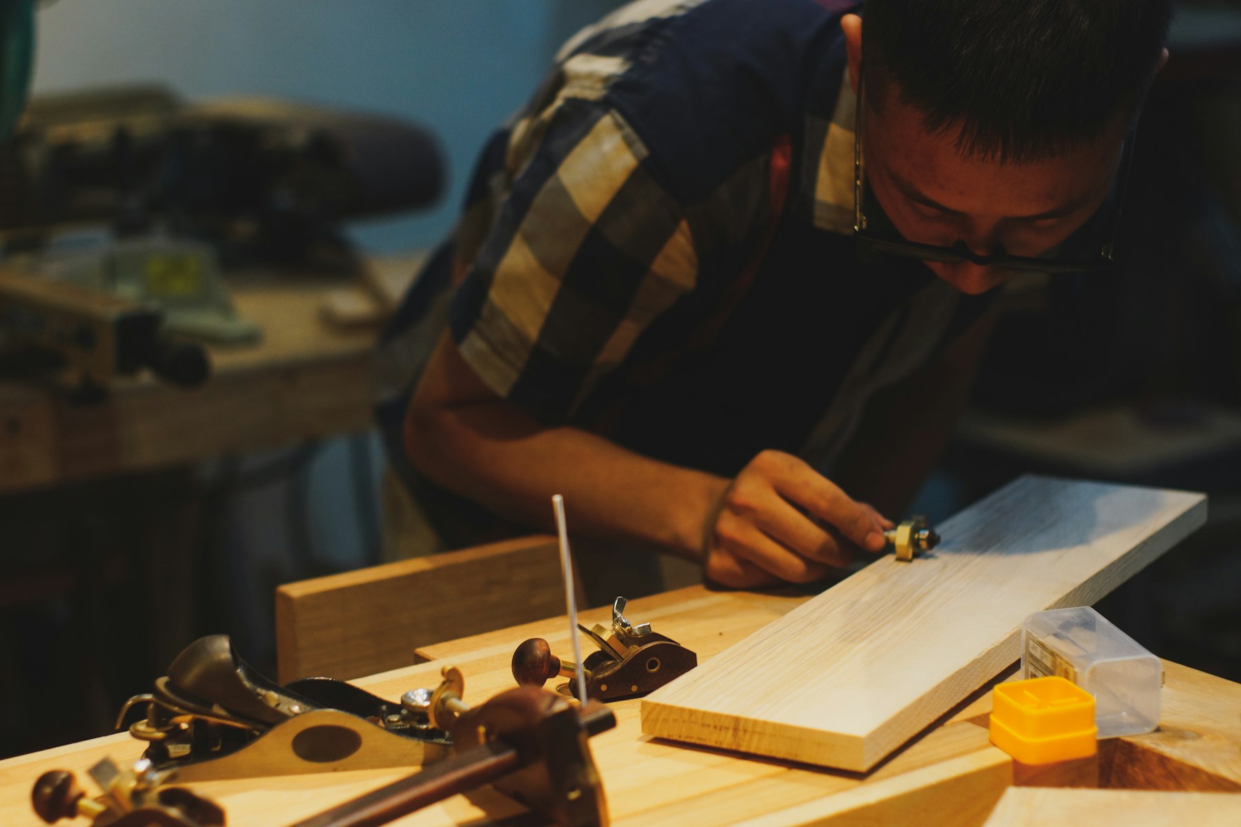 Carpintero trabajando la madera con herramientas de mano en su taller
